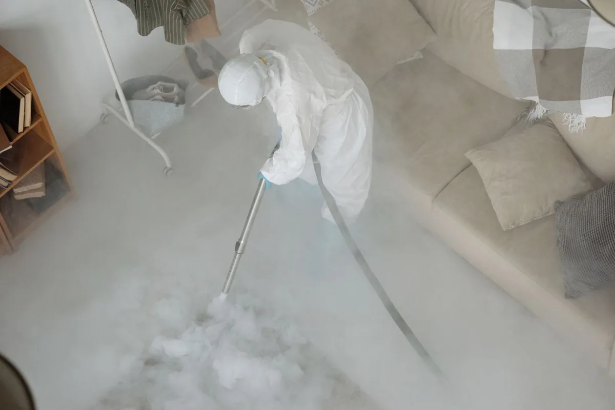 Biohazard cleanup technician in protective equipment, L Streets, Dallas, TX